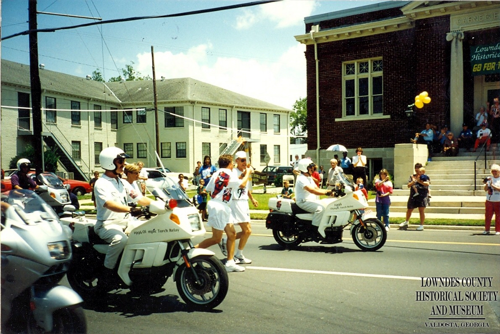The Olympic torch passing by the Lowndes County Historical Museum
